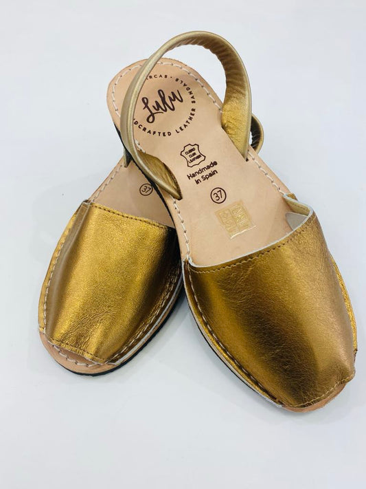 LULU AVARCAS BLACK WEDGE LEATHER SANDAL IN MATTE GOLD