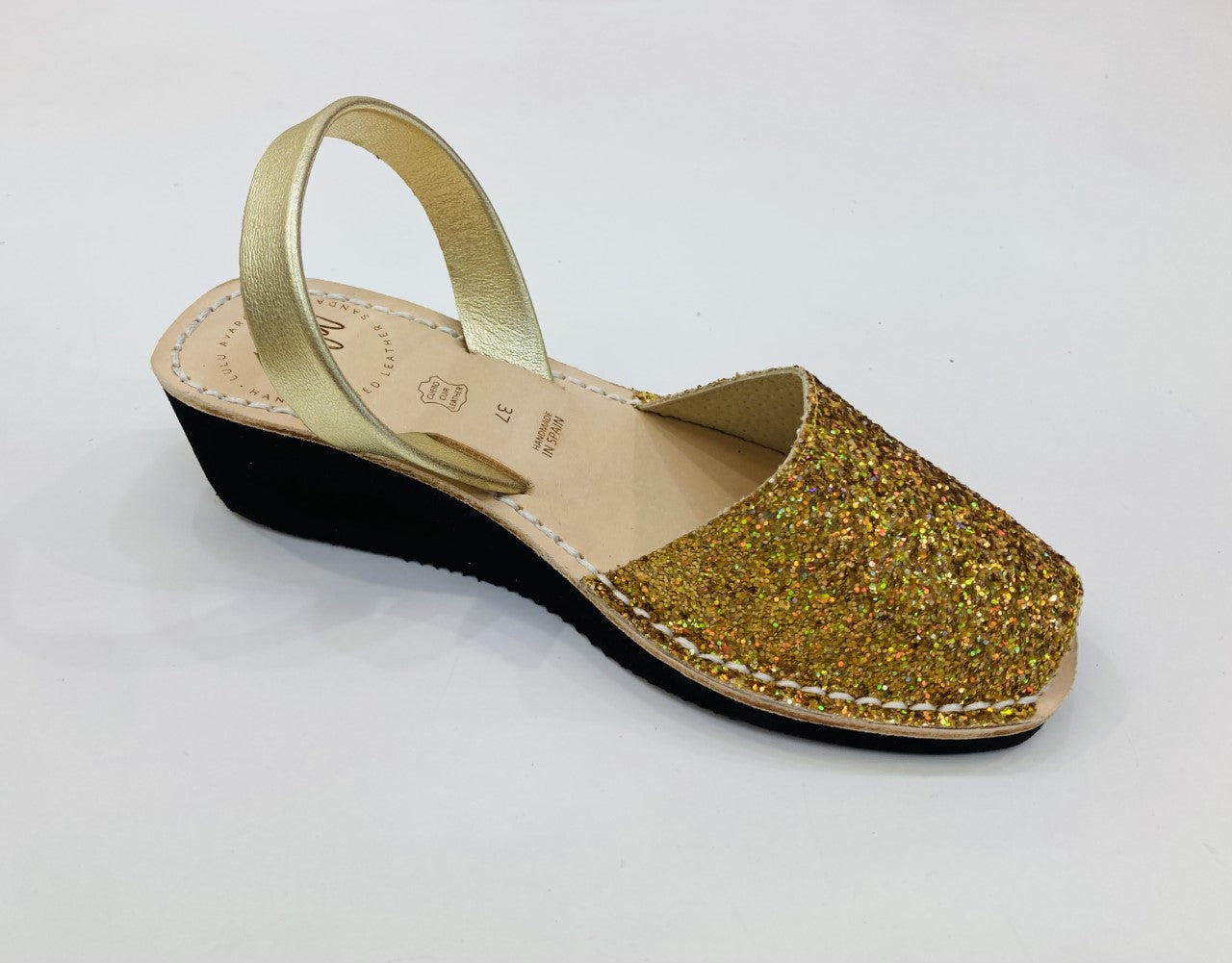 LULU AVARCAS LEATHER BLACK WEDGE IN GOLD GLITTER