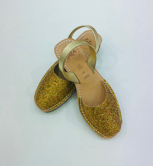 LULU AVARCAS BLACK WEDGE LEATHER SANDAL IN GOLD GLITTER