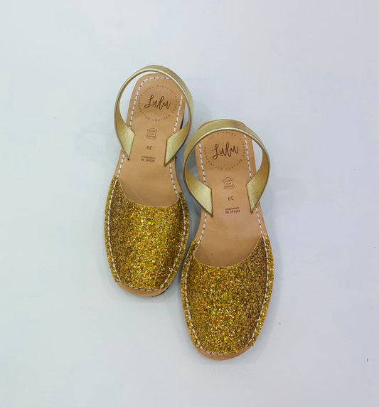 LULU AVARCAS BLACK WEDGE LEATHER SANDAL IN GOLD GLITTER